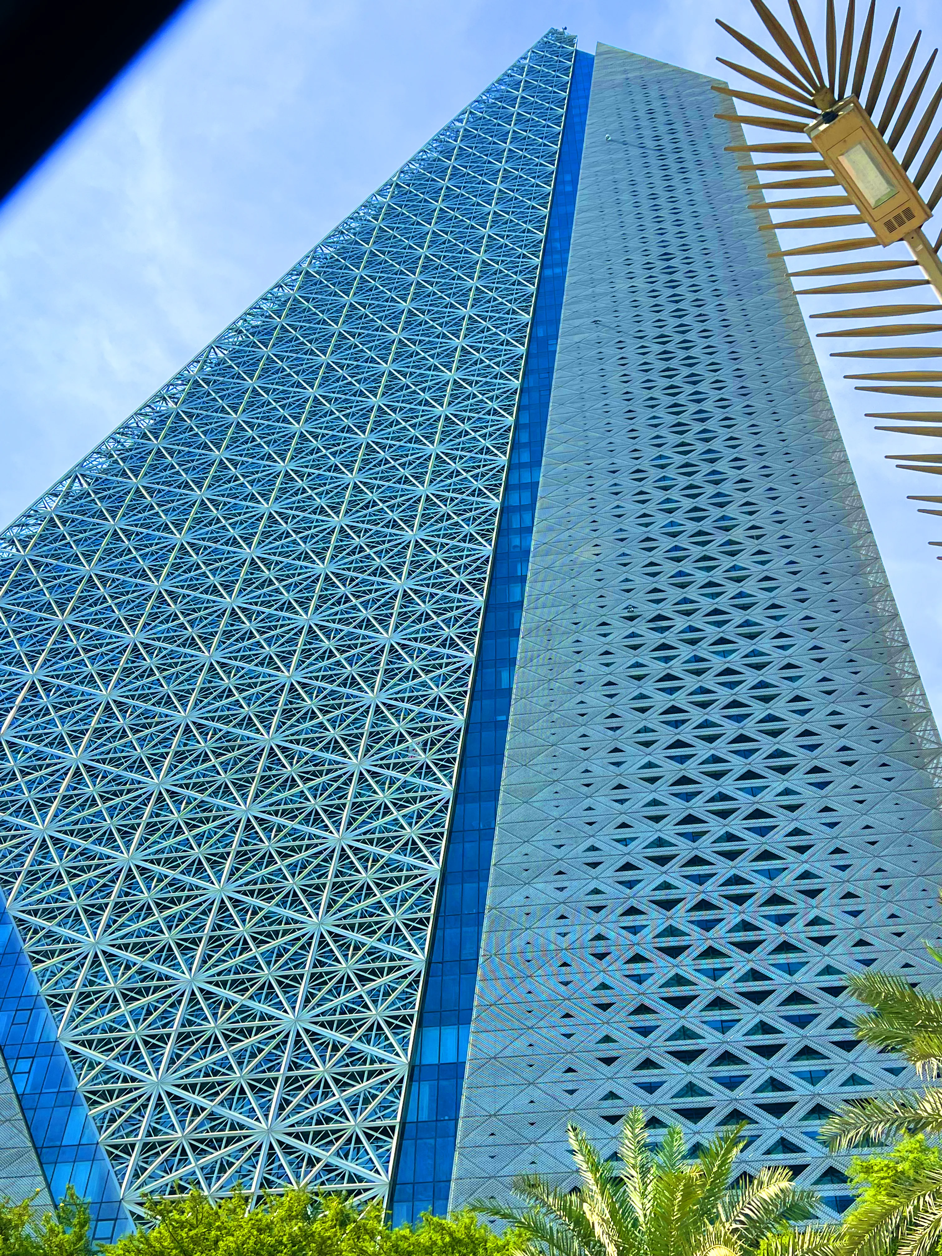 Close angle of Burj Doha's lattice facade rising above West Bay, Doha