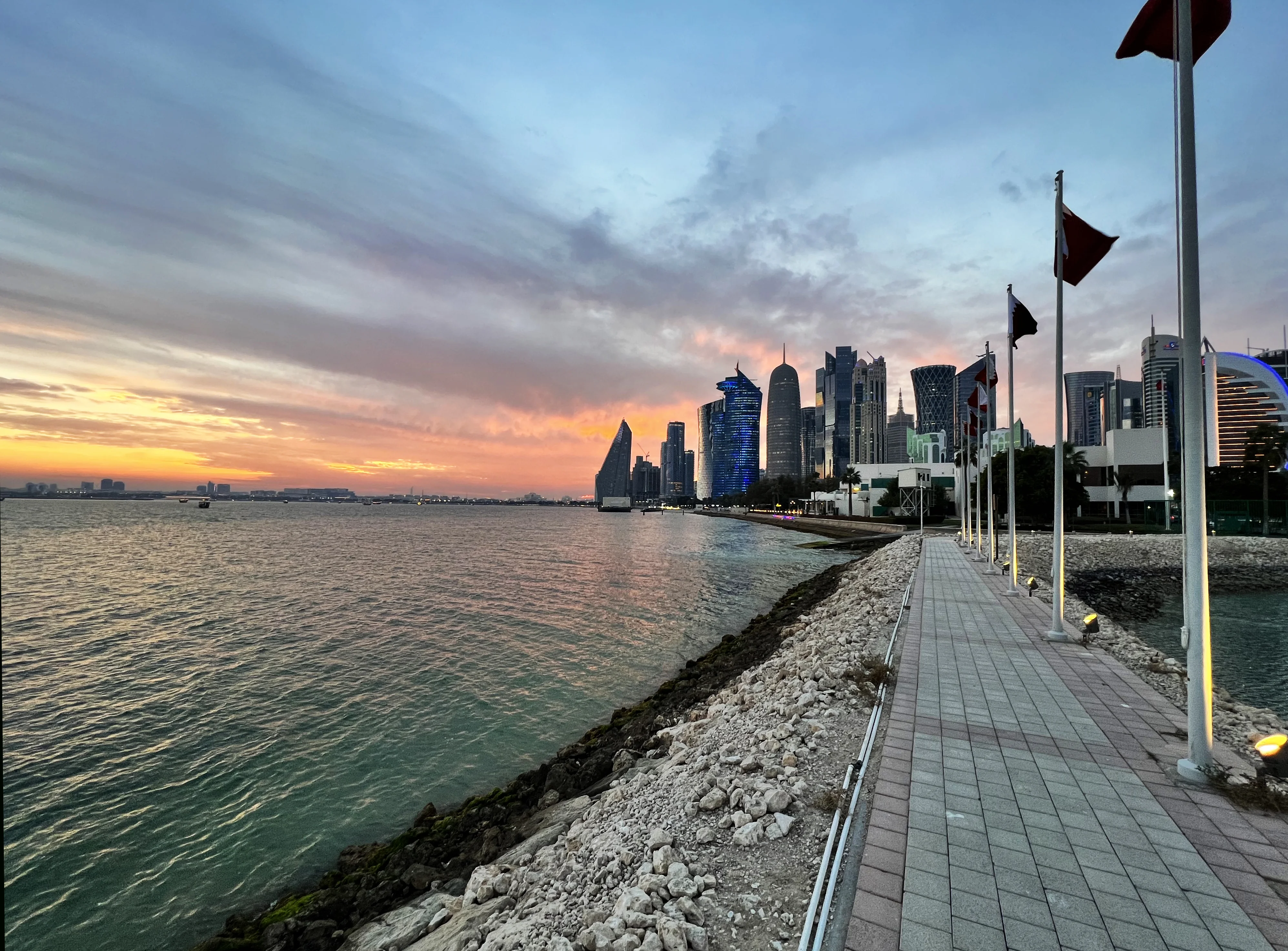 West Bay skyline at sunset viewed from the waterfront promenade, Doha
