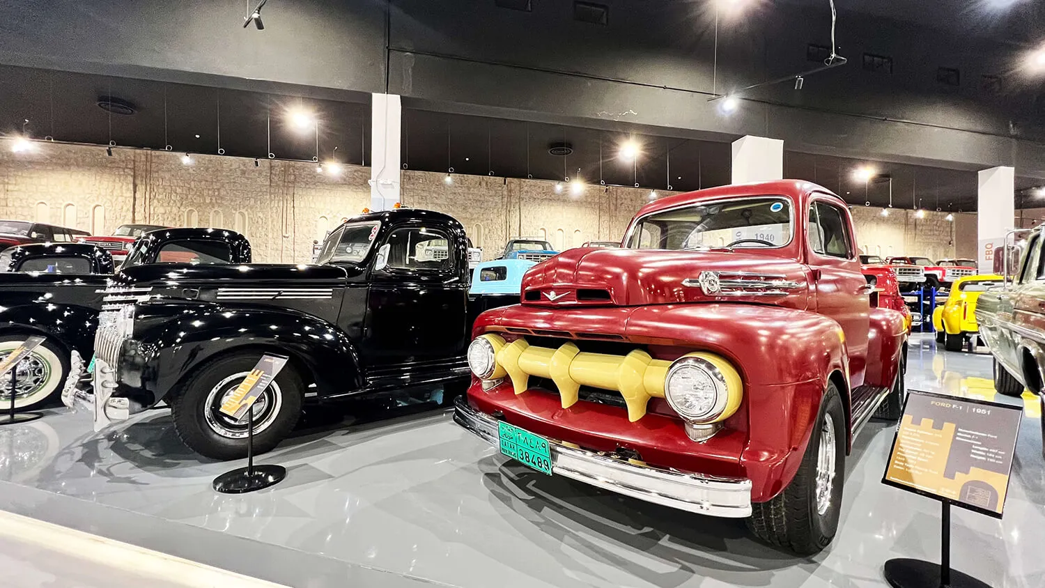 Vintage pickup trucks with chrome grilles on display in the car museum