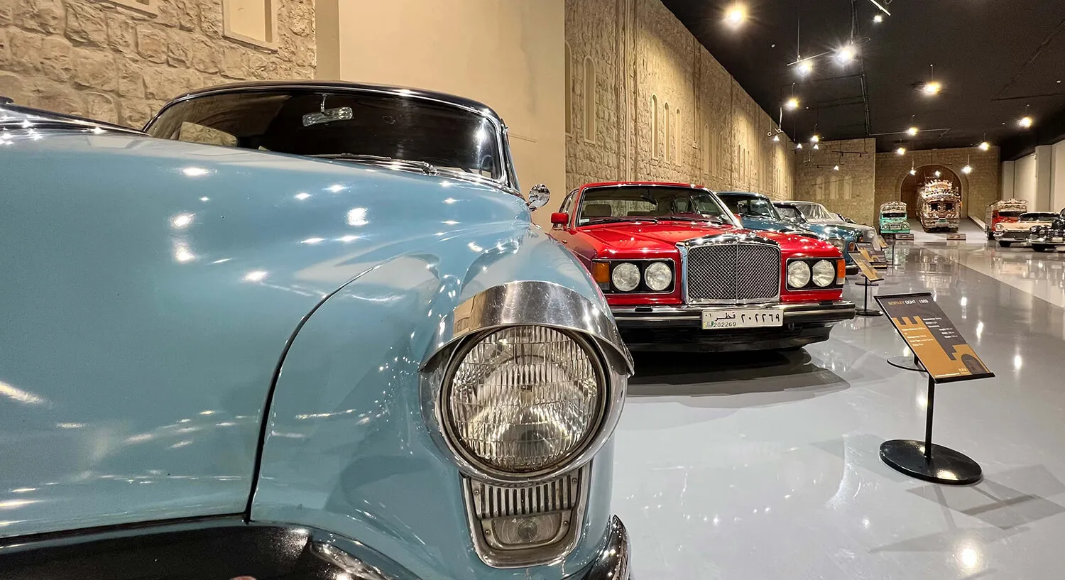 Pale blue vintage convertible with chrome grille on display