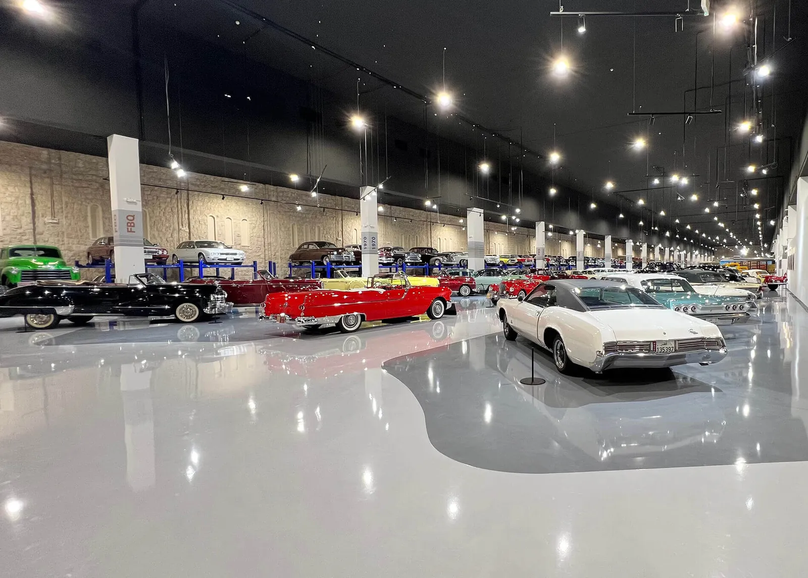 Wide view of the car museum gallery hall with rows of classic cars