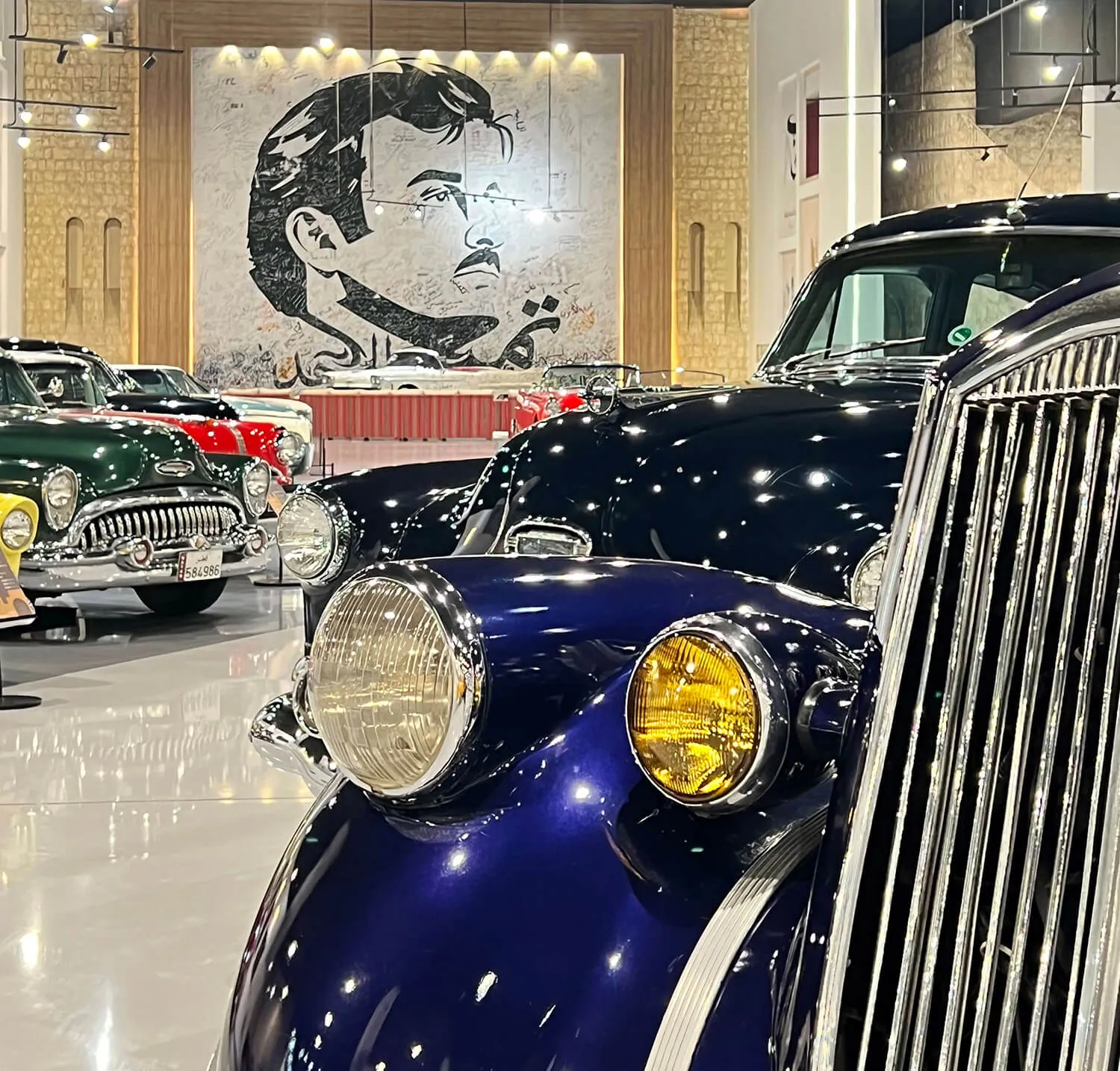 Dark blue vintage car with an ornate chrome radiator grille on display