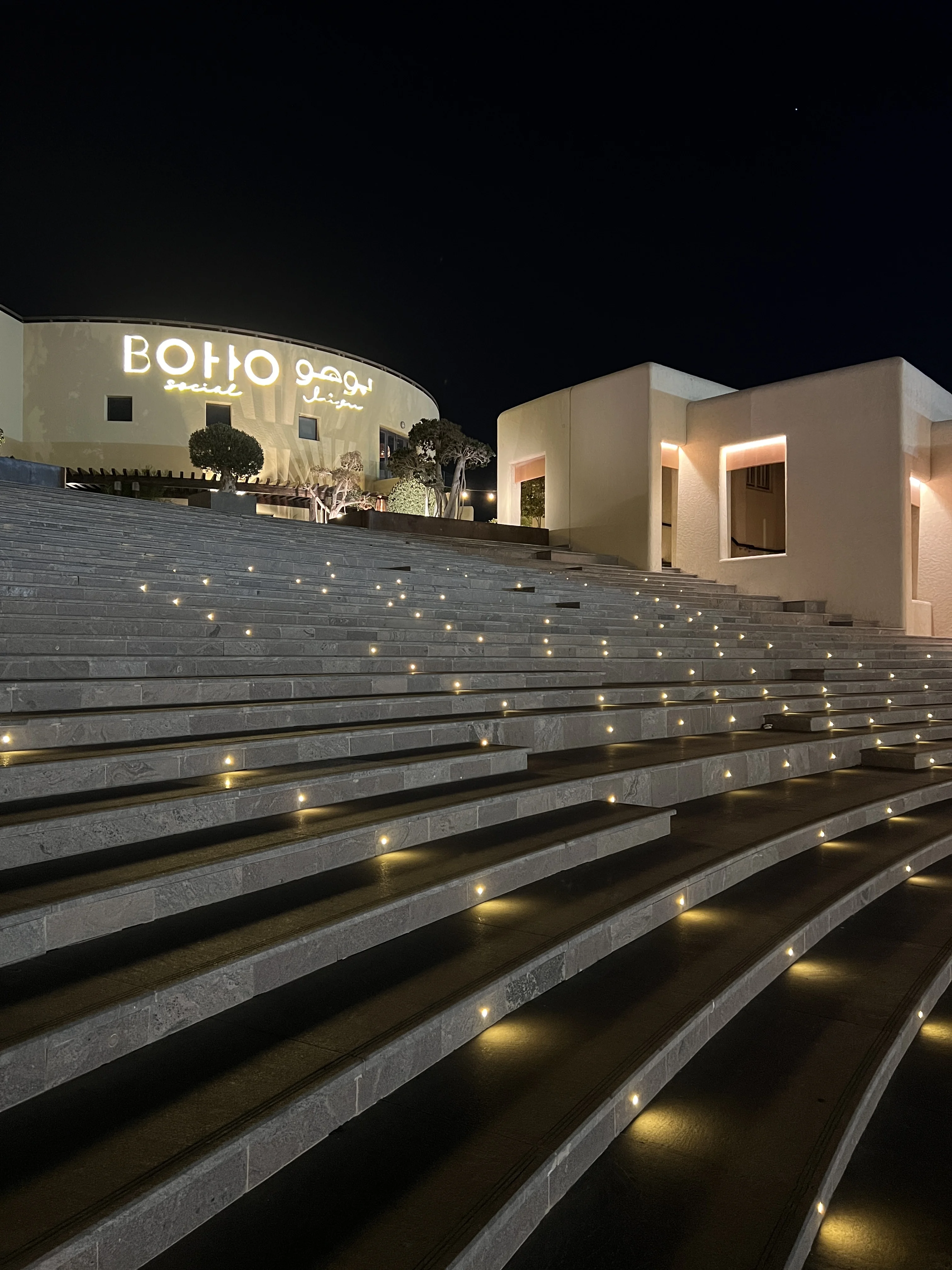 Elevated panoramic view of Katara Amphitheatre's seating bowl at dusk
