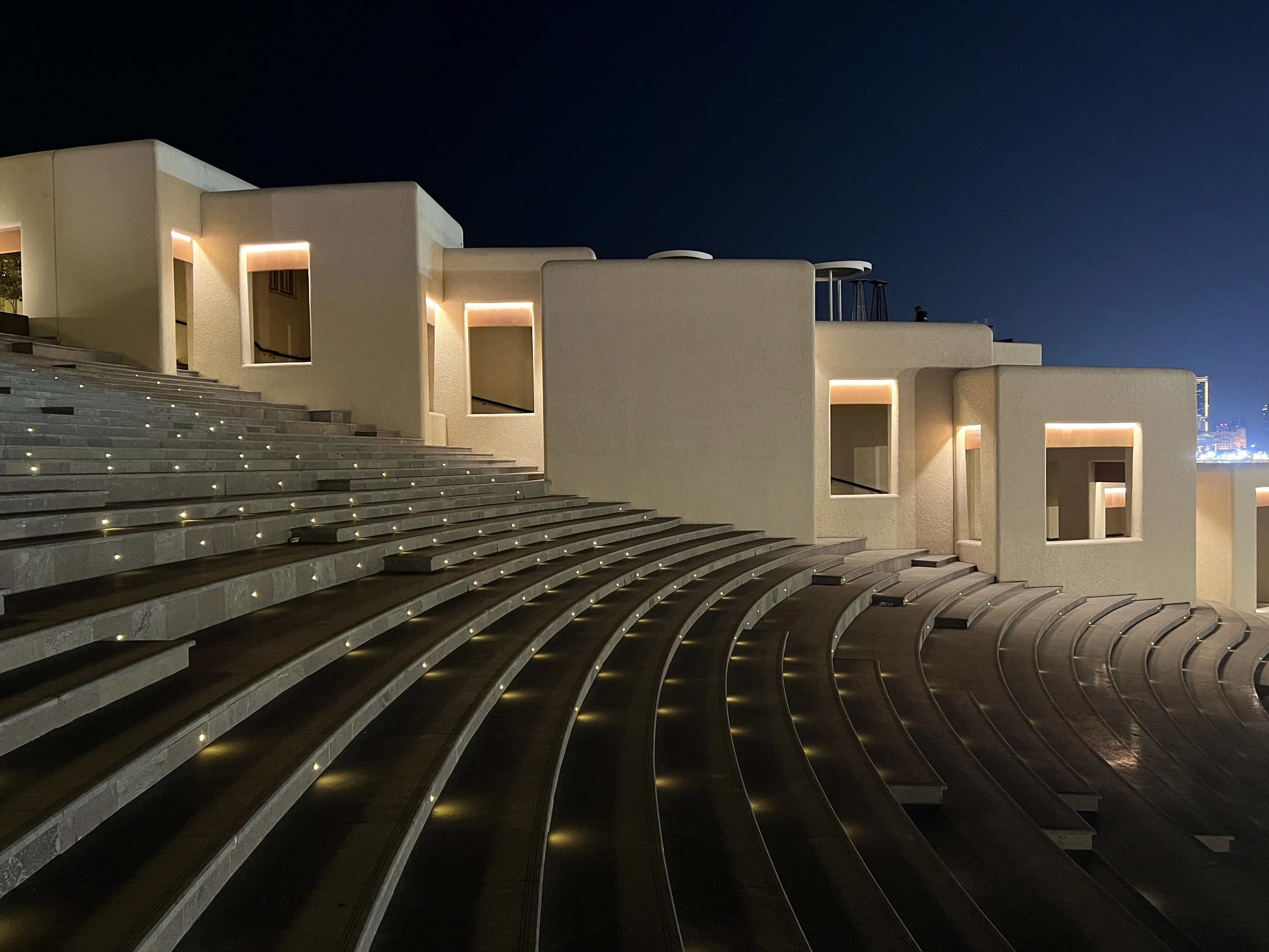 Close view of stone seating tiers at Katara Amphitheatre at night