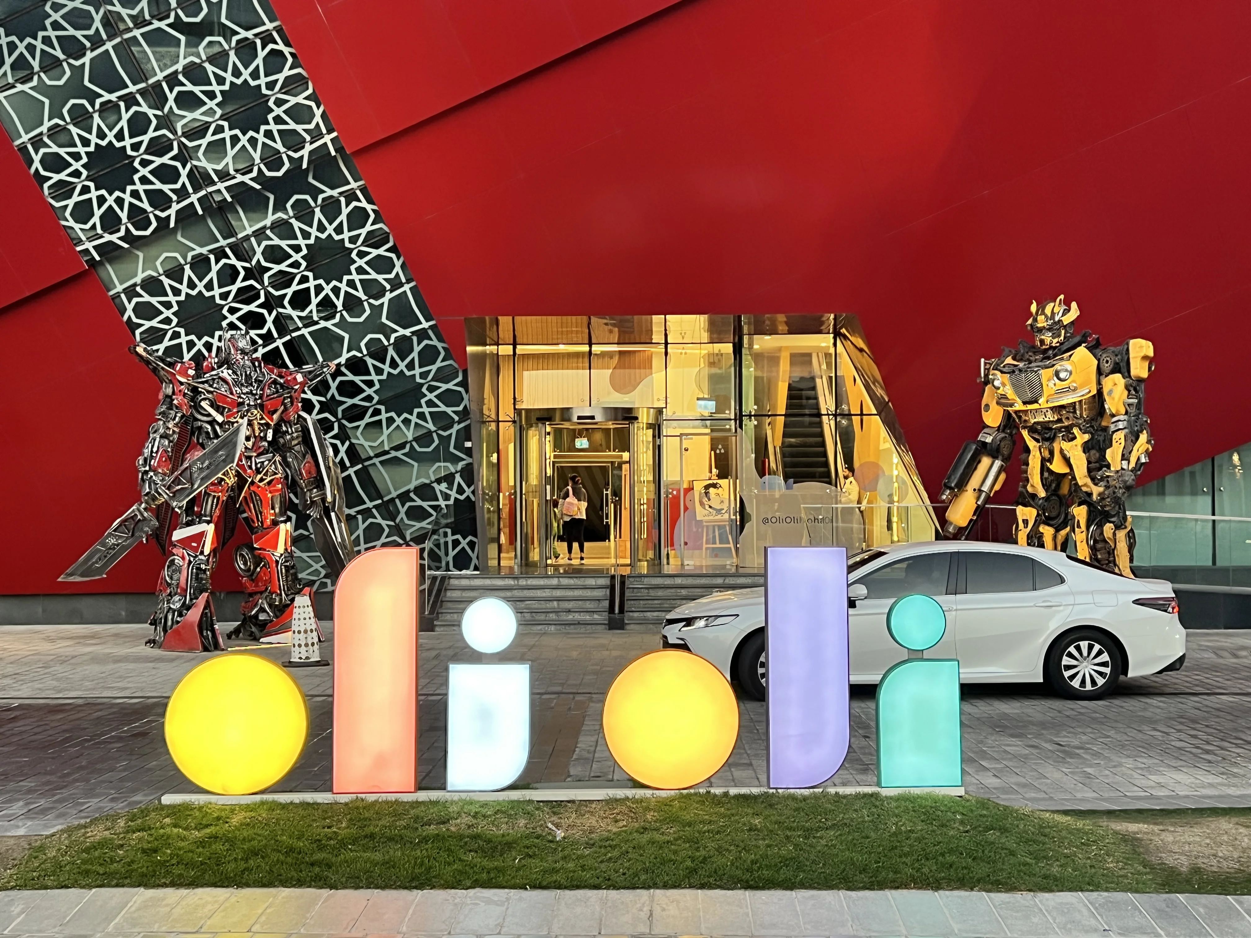 Large robot-style statues and colourful figures outside the Children's Mall entrance at Katara