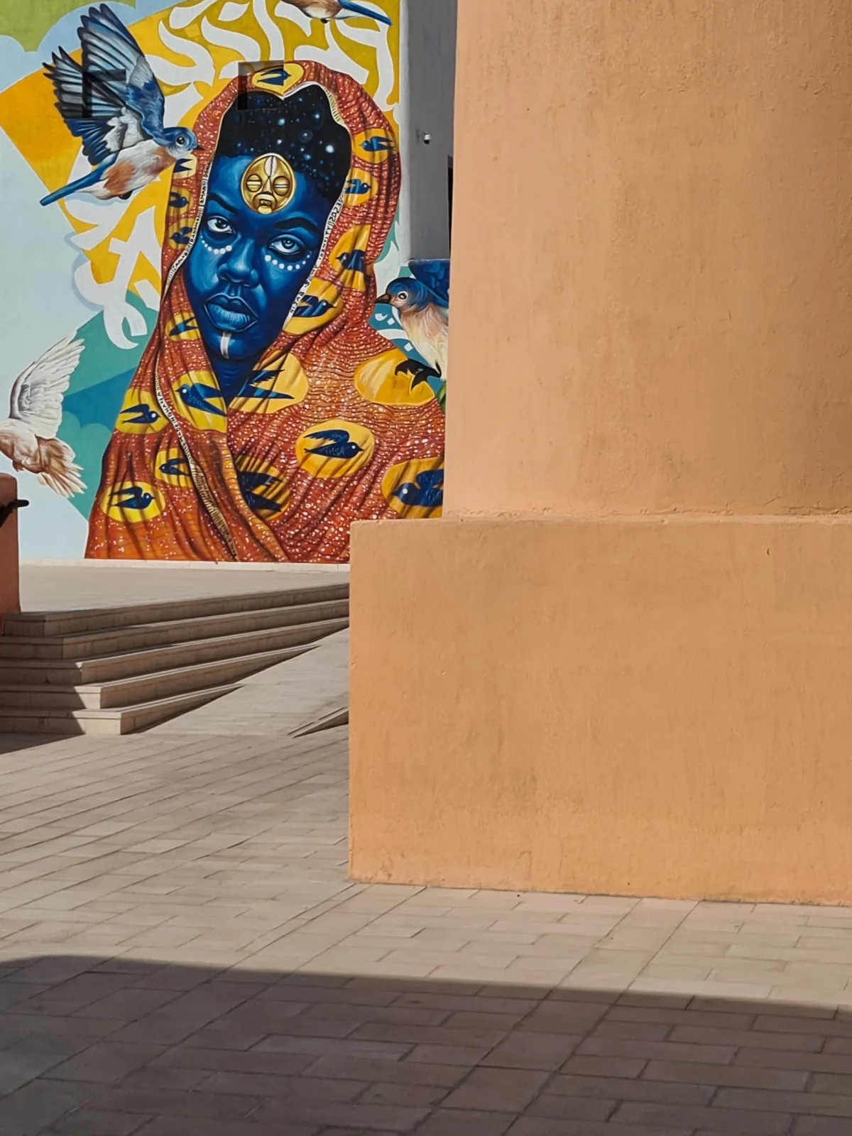 Colourful street art mural on a terracotta wall in the Mina District, Doha