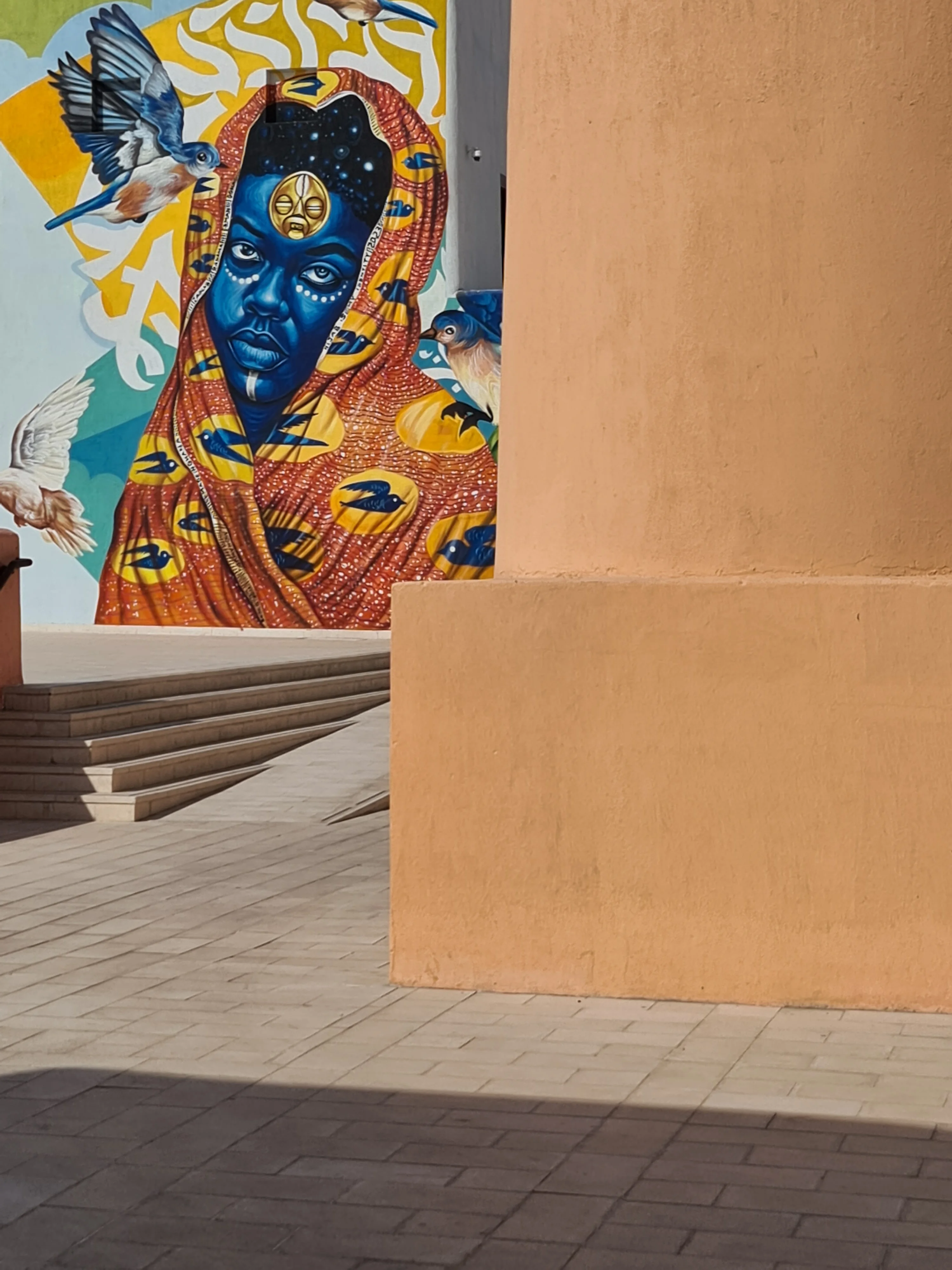 Colourful street art mural on a terracotta wall in the Mina District, Doha