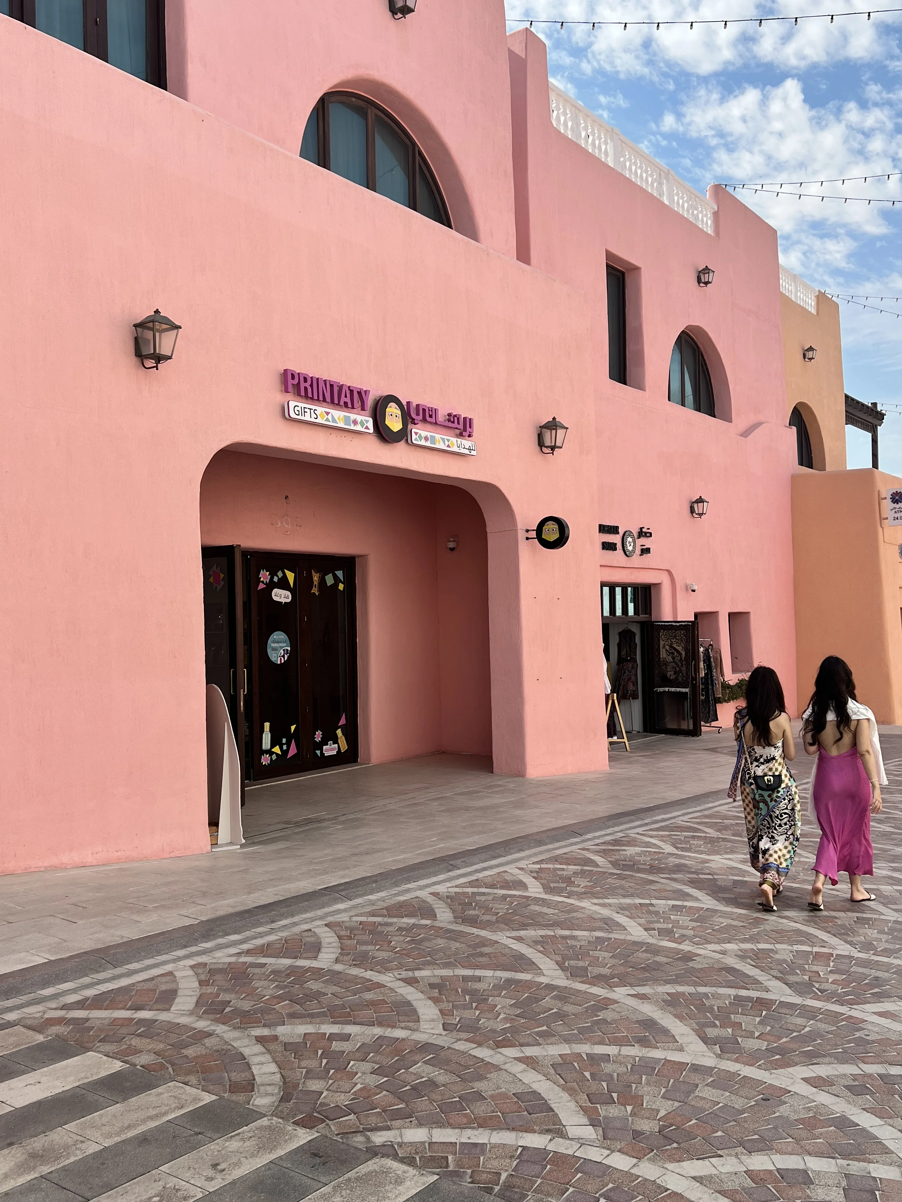 Pastel-coloured street with cobblestone paving in the Mina District, Doha