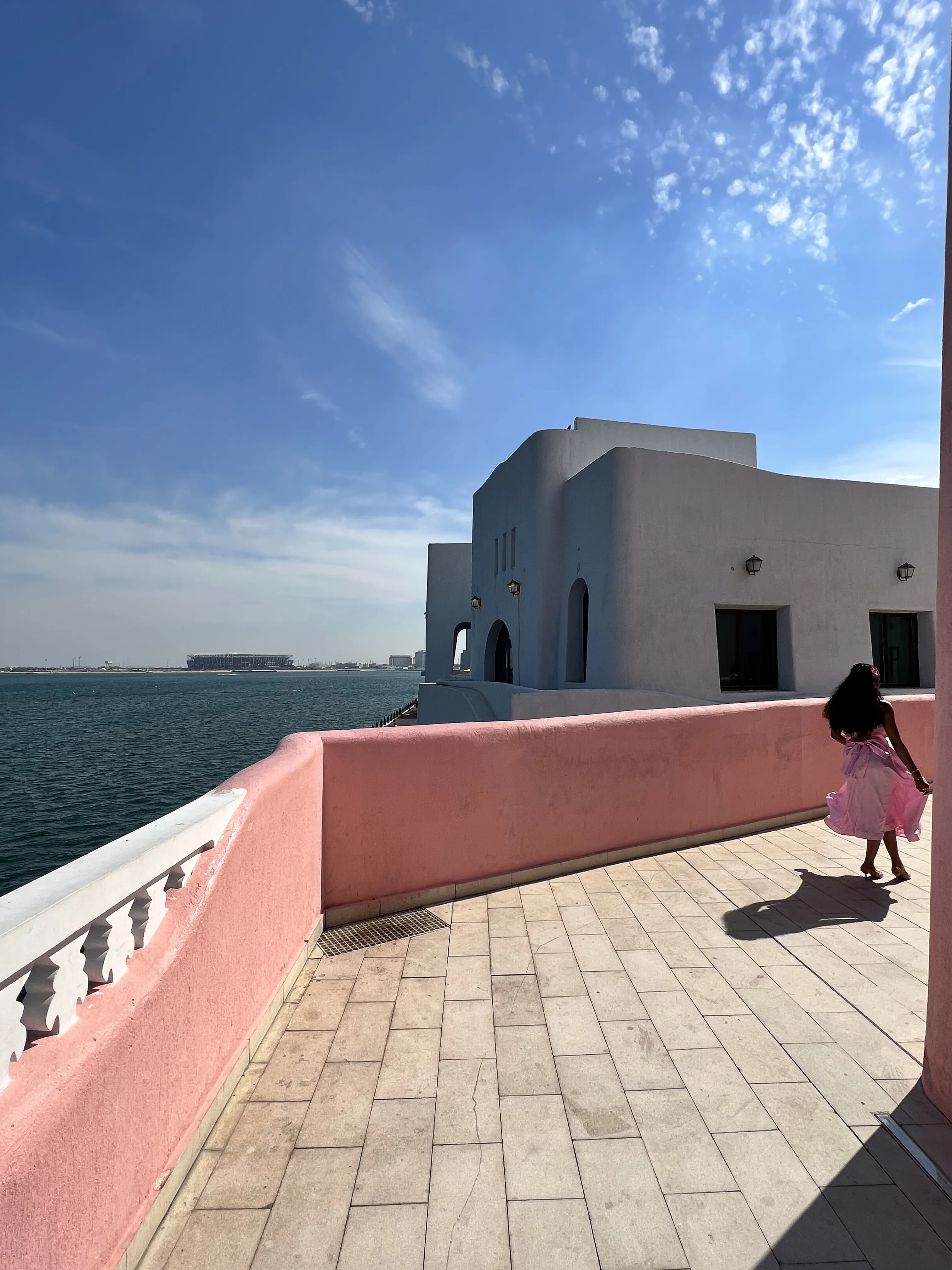 Grey stone waterfront promenade overlooking the sea in the Mina District, Doha