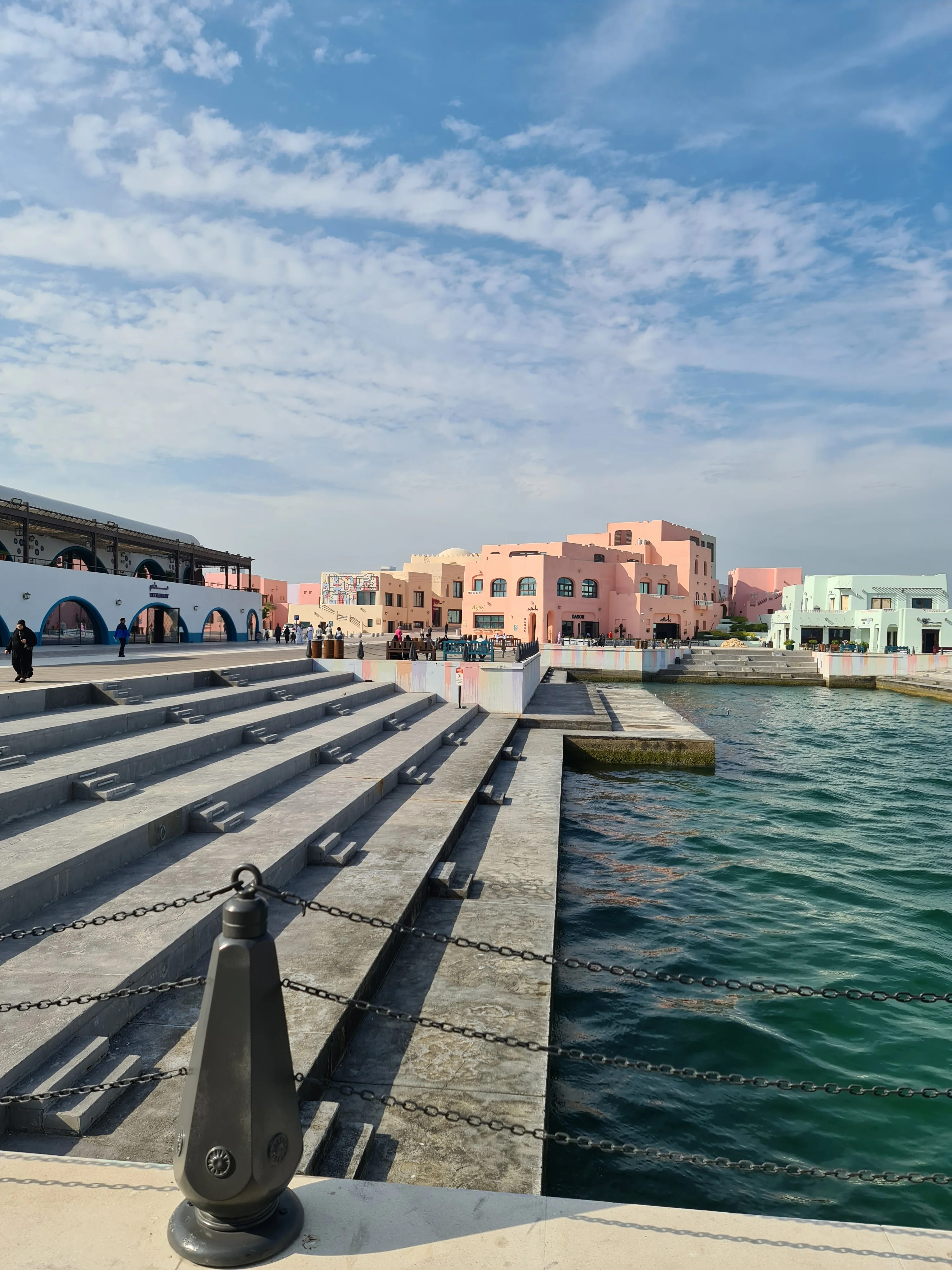 Stepped stone waterfront seating overlooking the harbour basin in the Mina District, Doha